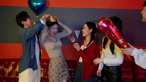 Young friends having fun at birthday karaoke party