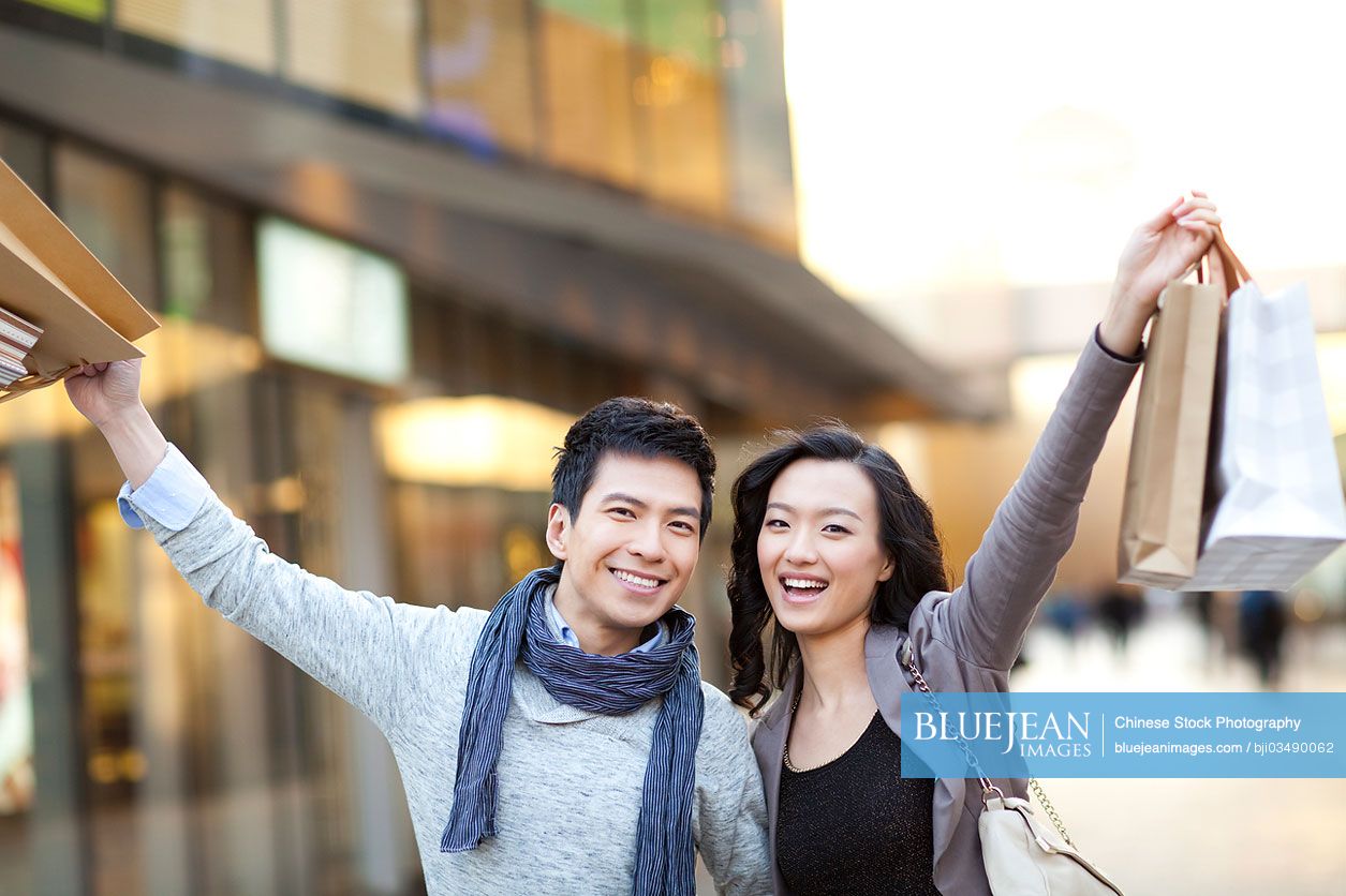 Fashionable young Chinese couple shopping