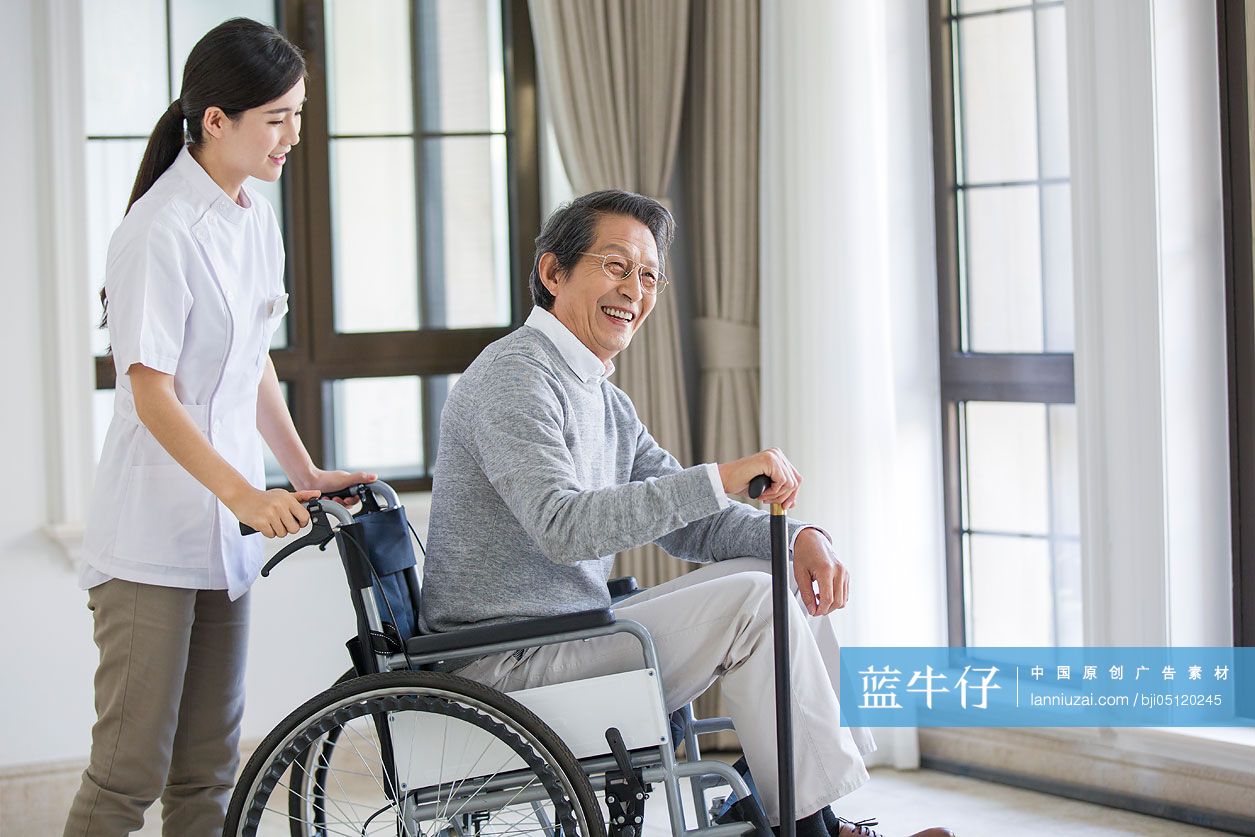 护工照顾坐着轮椅的老年男子