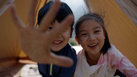 Cute Chinese Children relaxing in tent