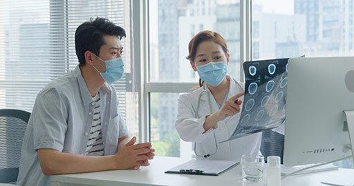 Chinese doctor discussing X-ray image with patient,4K