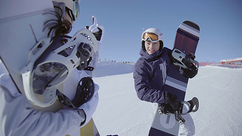 Young Chinese couple with snowboards on the snow,4K