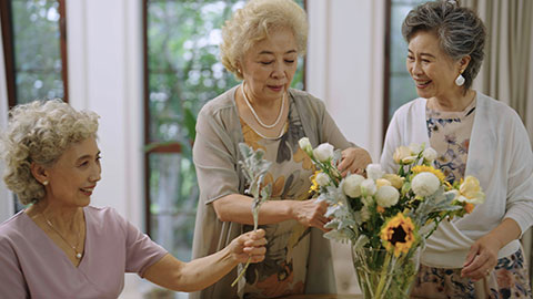 Happy senior Chinese friends arranging flowers together,4K