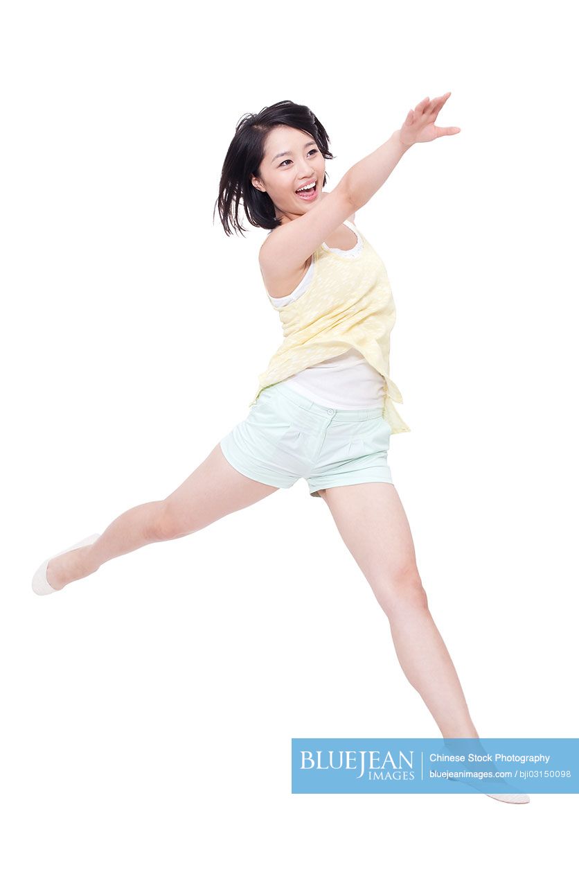 Happy young Chinese woman jumping