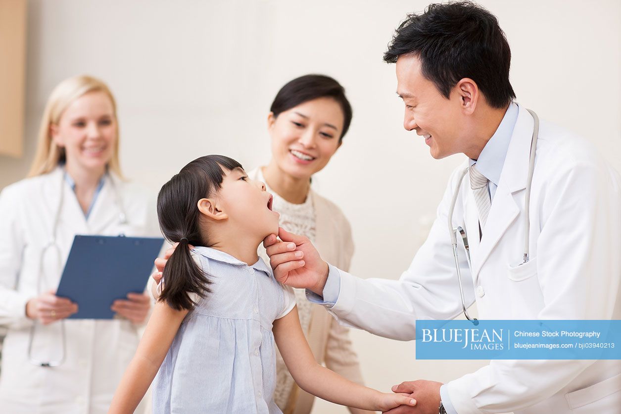 Chinese doctor examining little girl