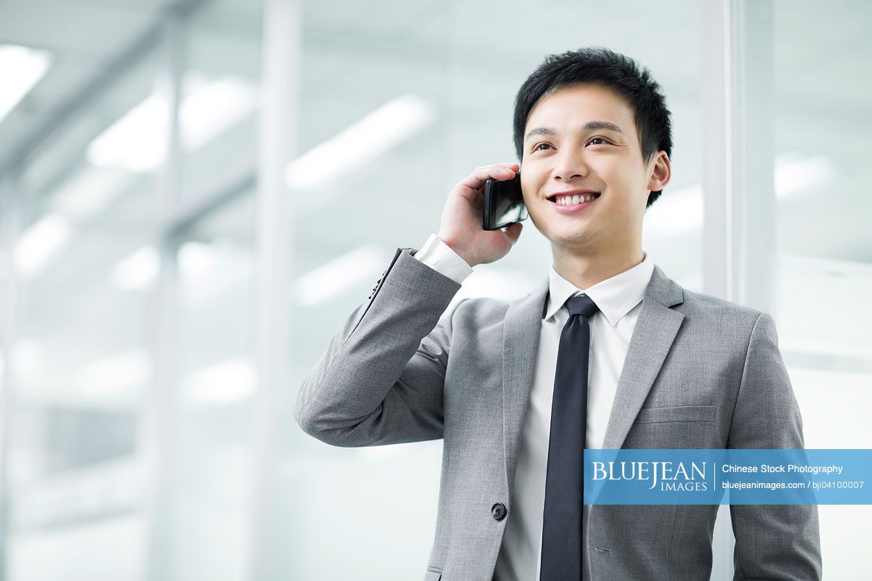 Young Chinese businessman talking on the phone