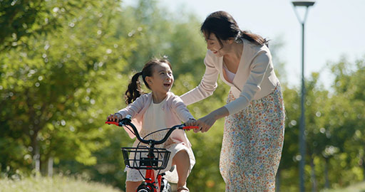 Chinese mother teaching daughter to ride bike,4K