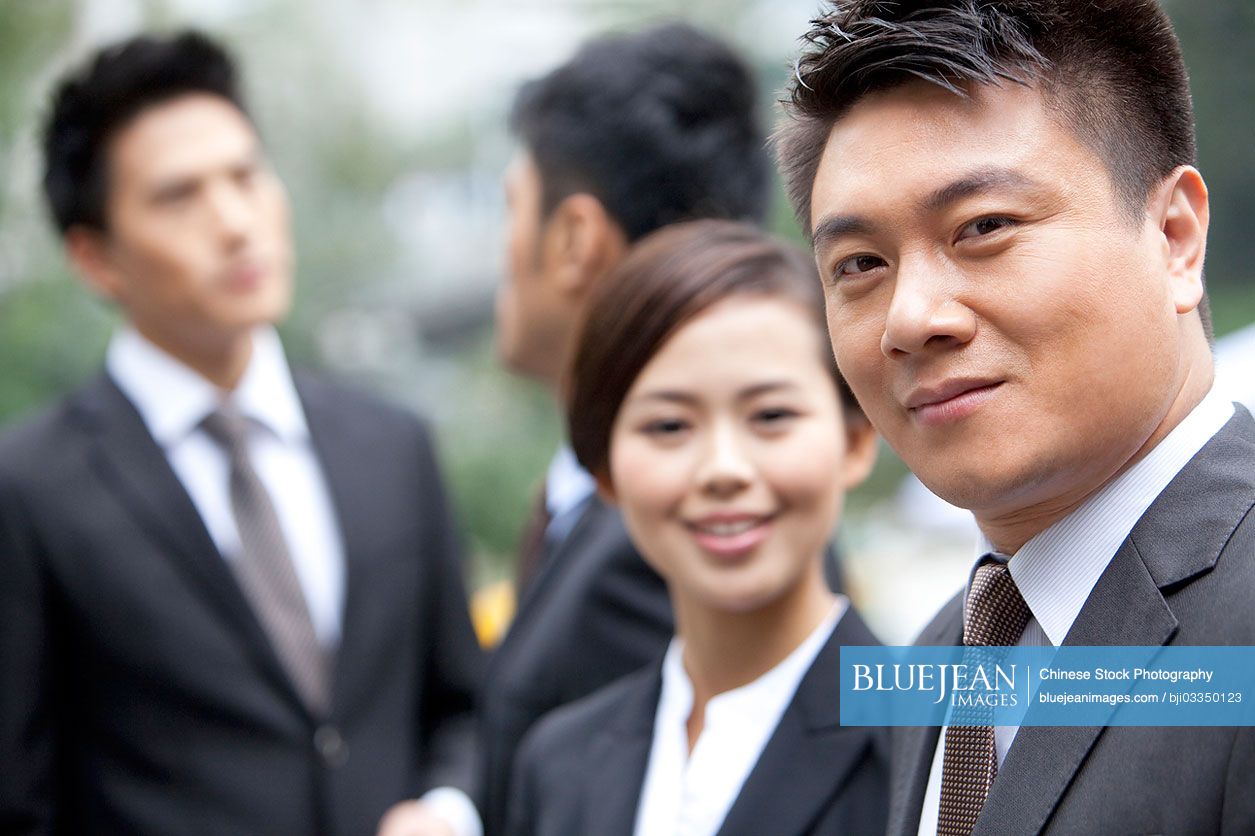 Adroit Chinese businessman with his team in Hong Kong