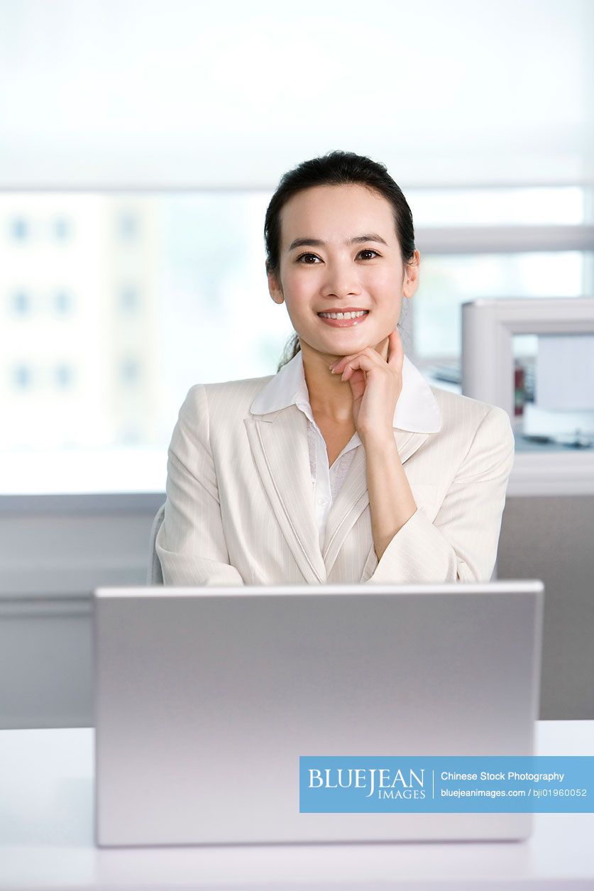 Chinese office worker at her desk