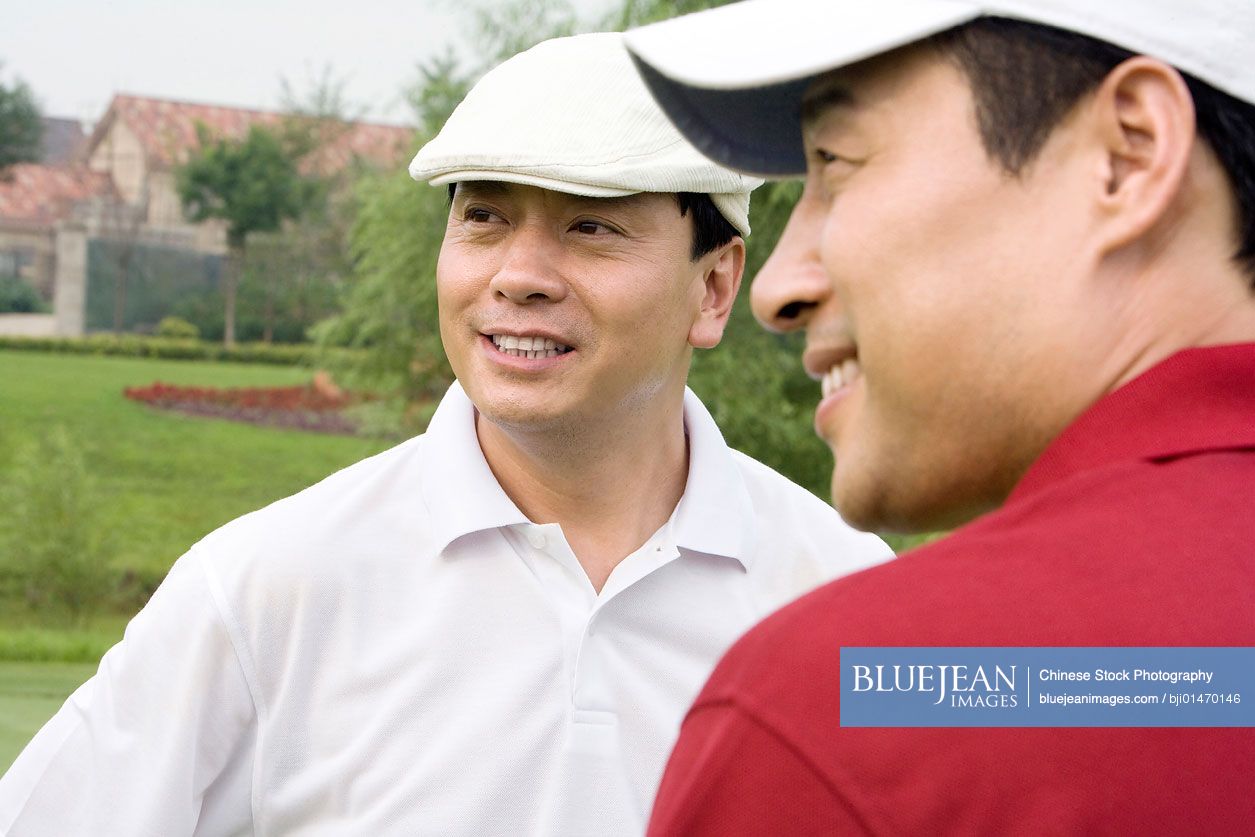 Portrait of two male Chinese golfers
