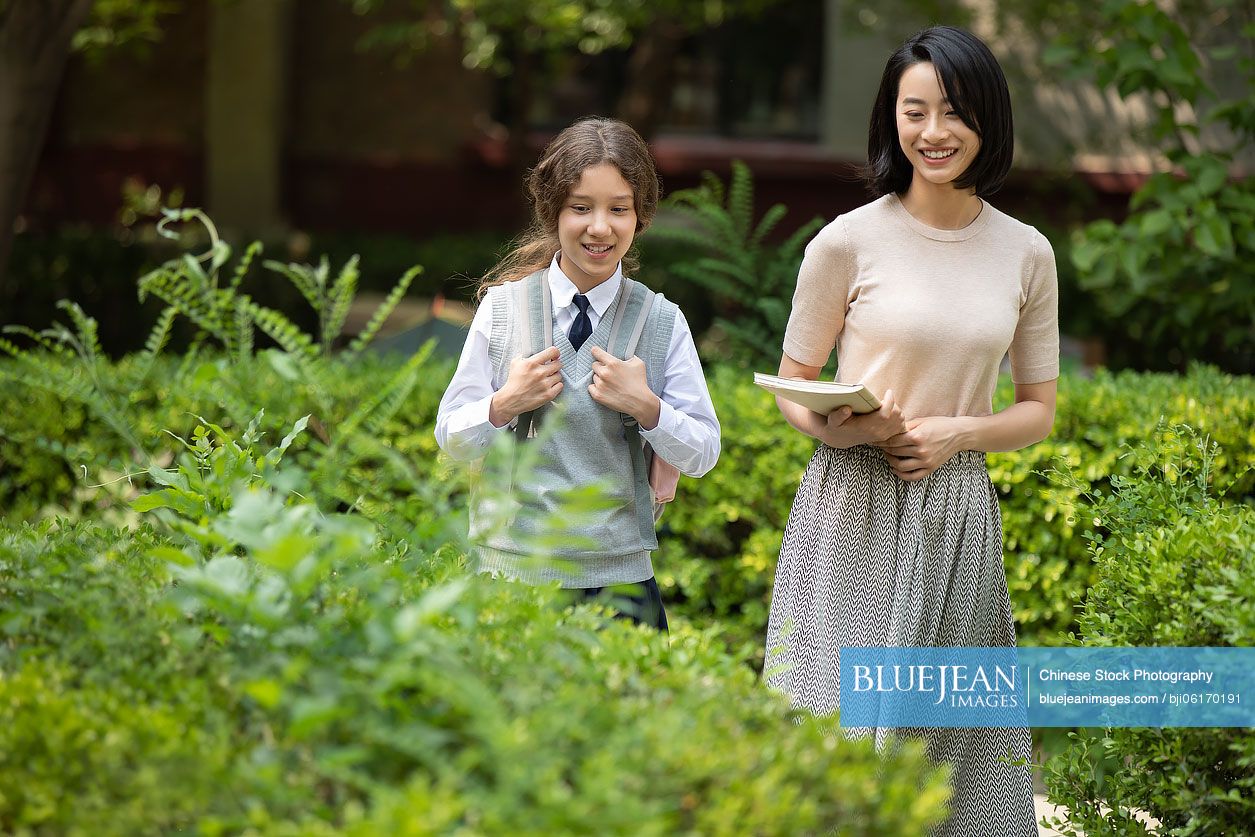Chinese teacher talking with student on campus