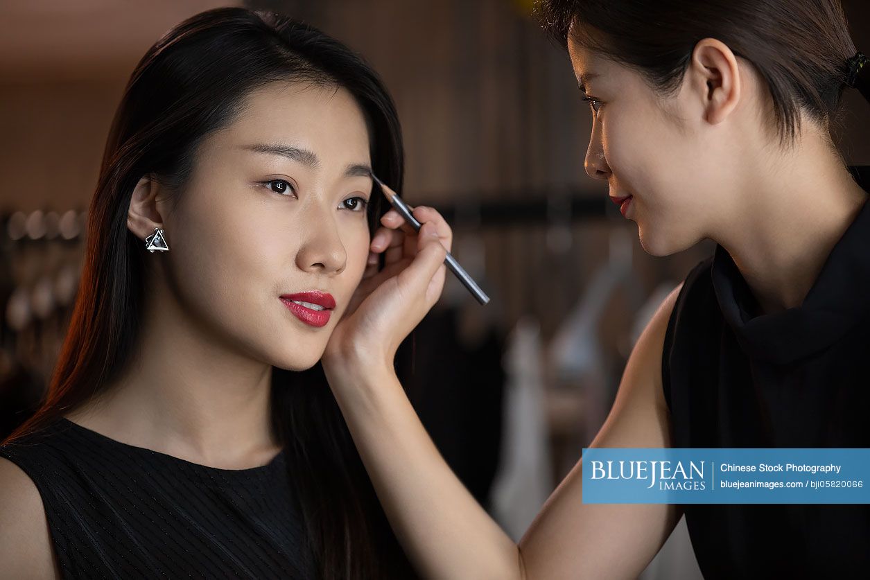 chinese-makeup-artist-applying-makeup-on-model-high-res-stock-photo-for