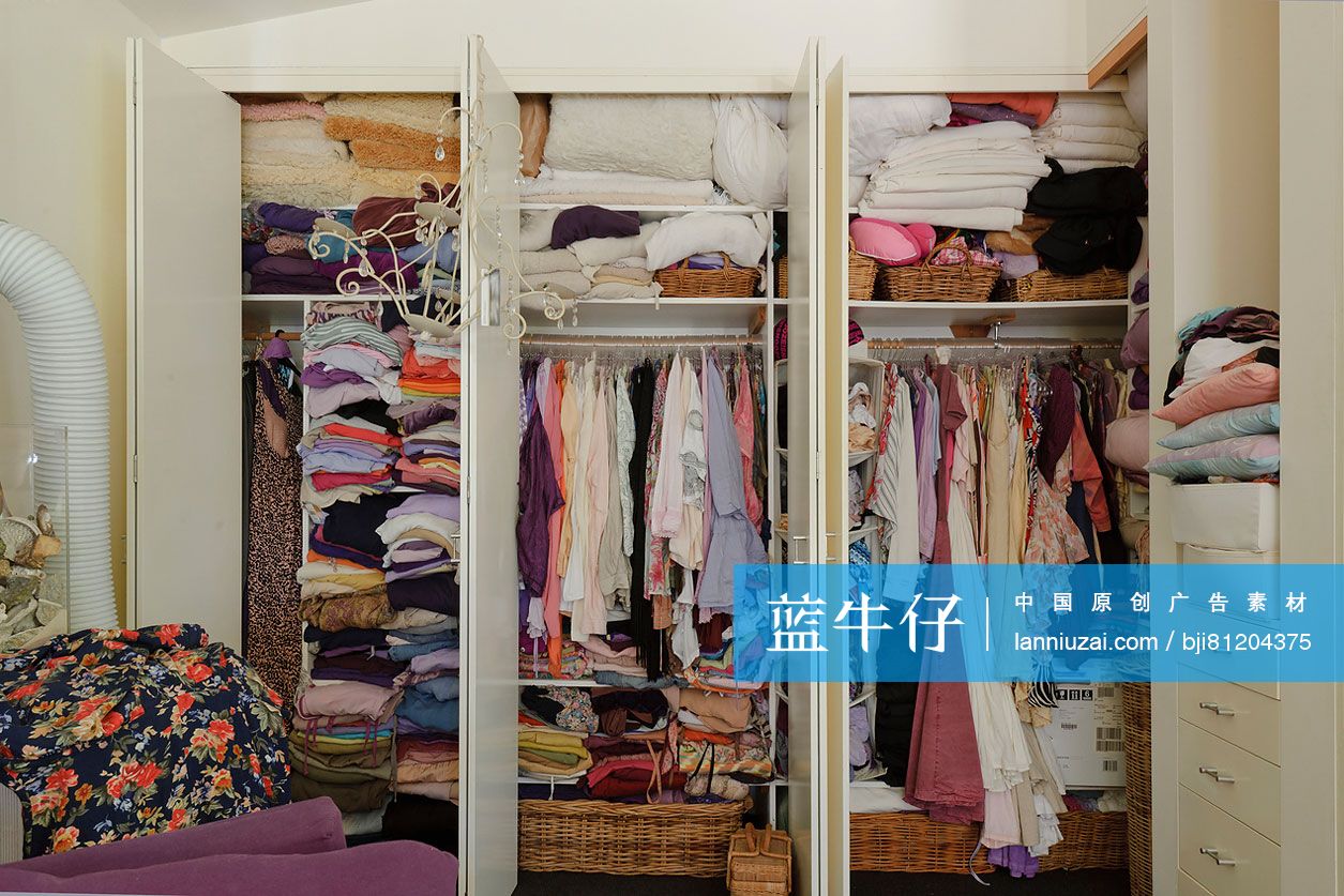 Close-up of clothes stacked in wardrobe at house