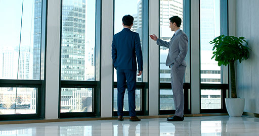 Young Chinese businessmen talking in office,4K