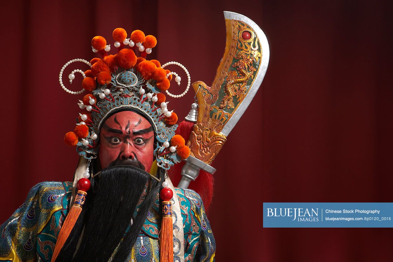 Chinese actor portraying Guang Dong, ancient Chinese general in  Beijing opera costume, represents protection and wealth