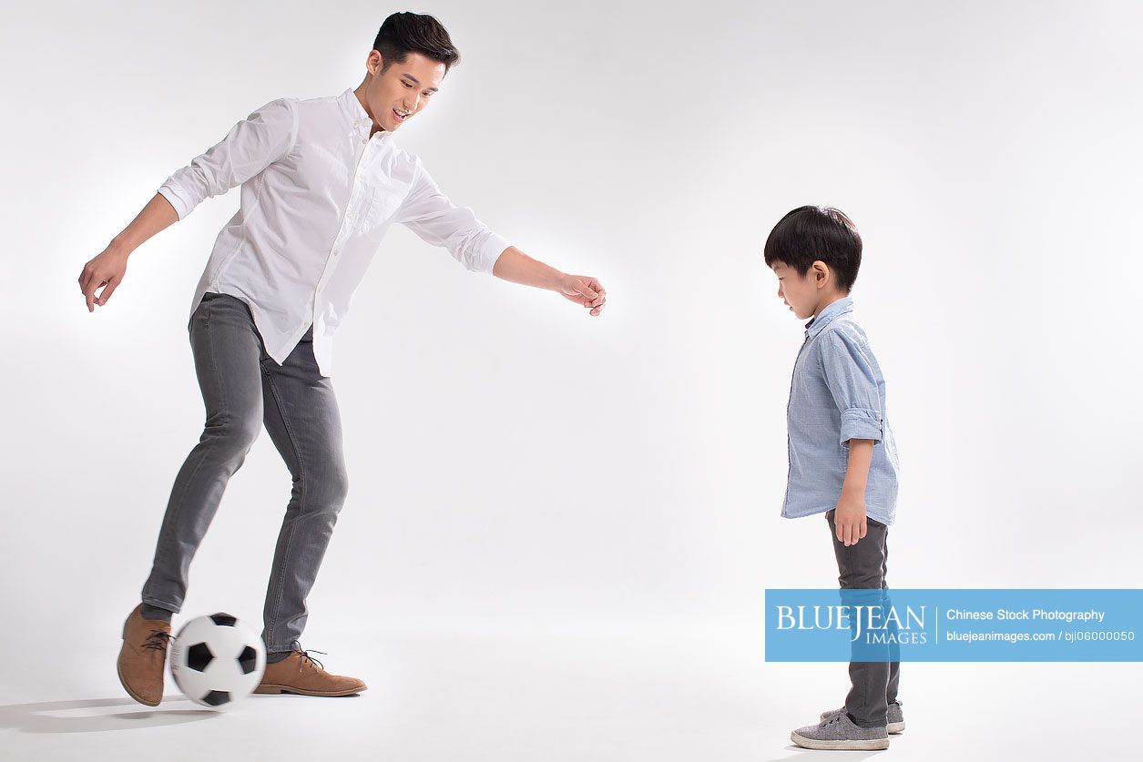 Chinese father and son playing football