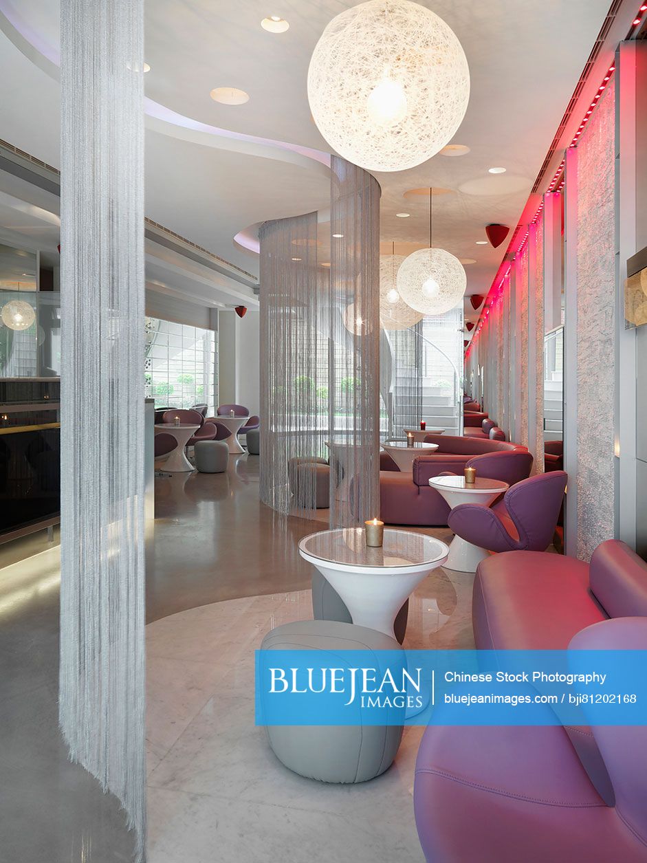 Lounge area through string curtains in modern nightclub