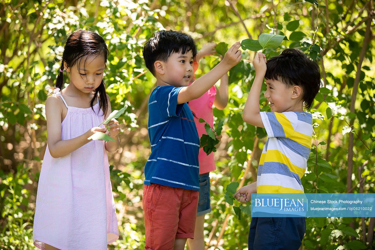 Happy Chinese children playing on meadow
