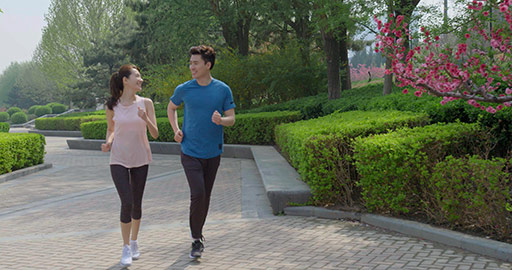 Happy young Chinese couple running in park,4K