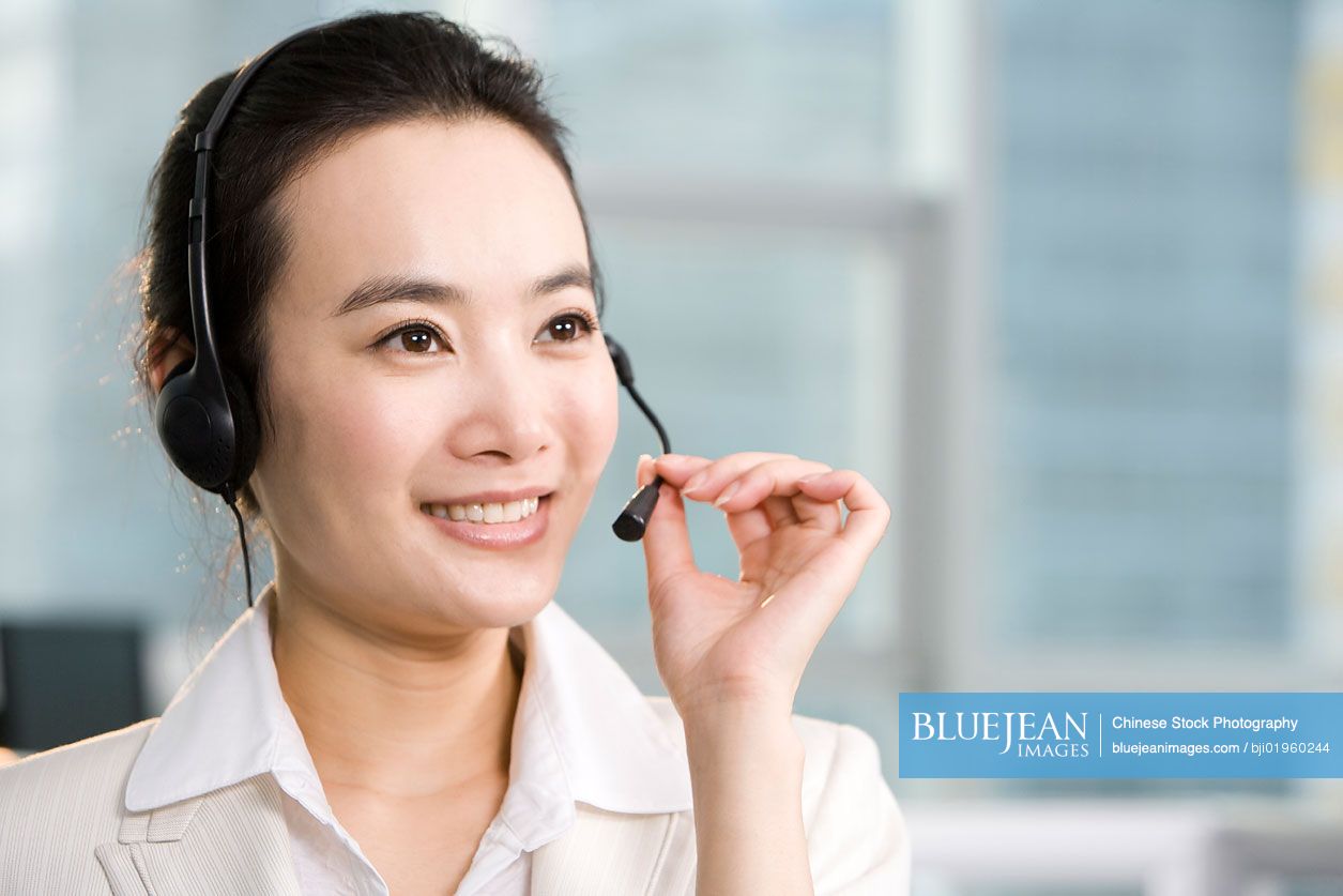 Chinese office worker with a headset