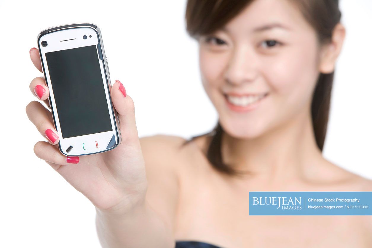 Young Chinese woman holding cell phone