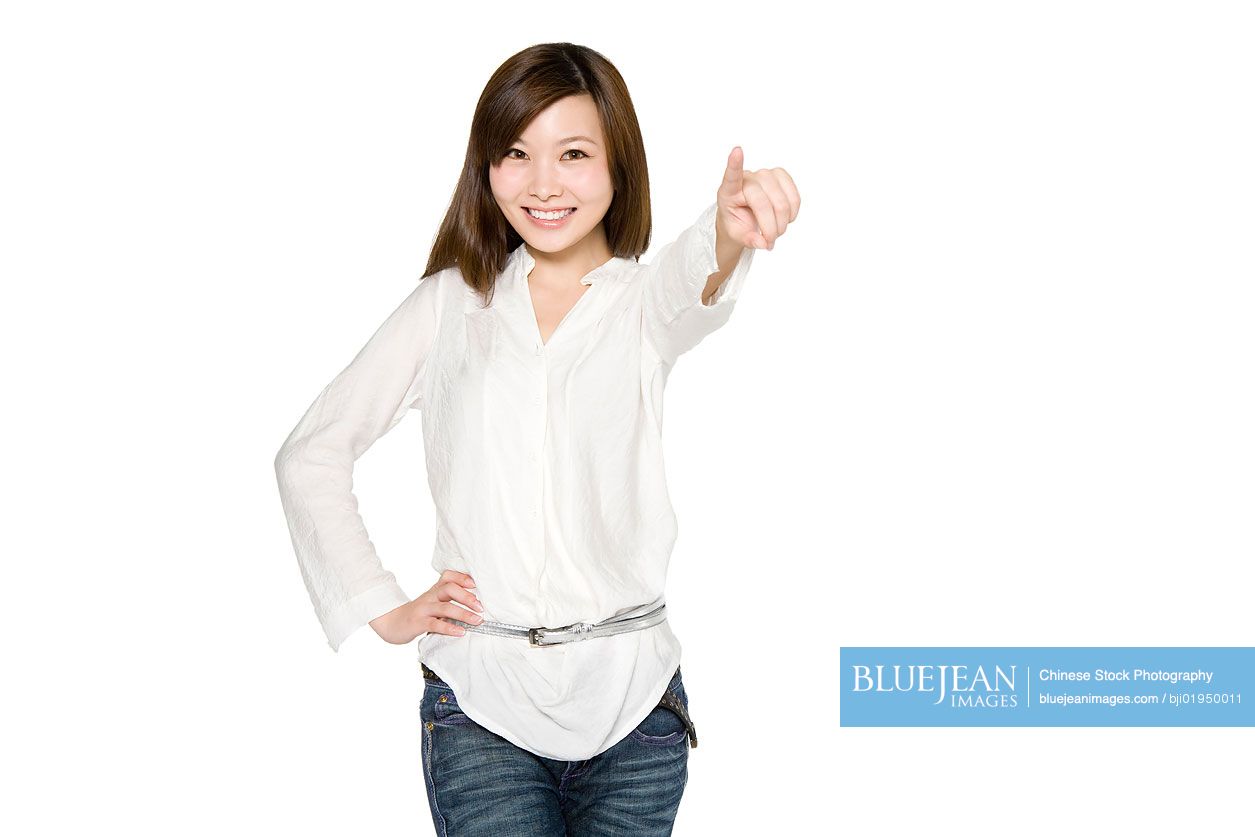 Portrait of young Chinese woman pointing