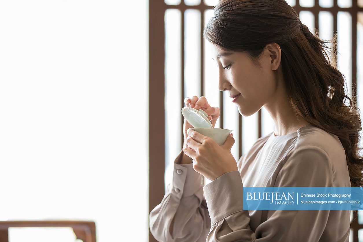 Young Chinese woman drinking tea