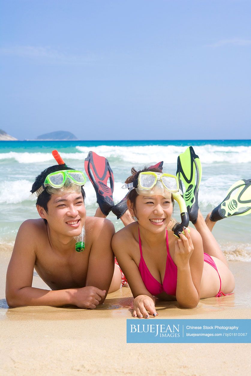 Young Chinese couple having fun at the beach