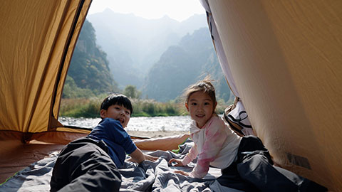 Cute Chinese Children relaxing in tent