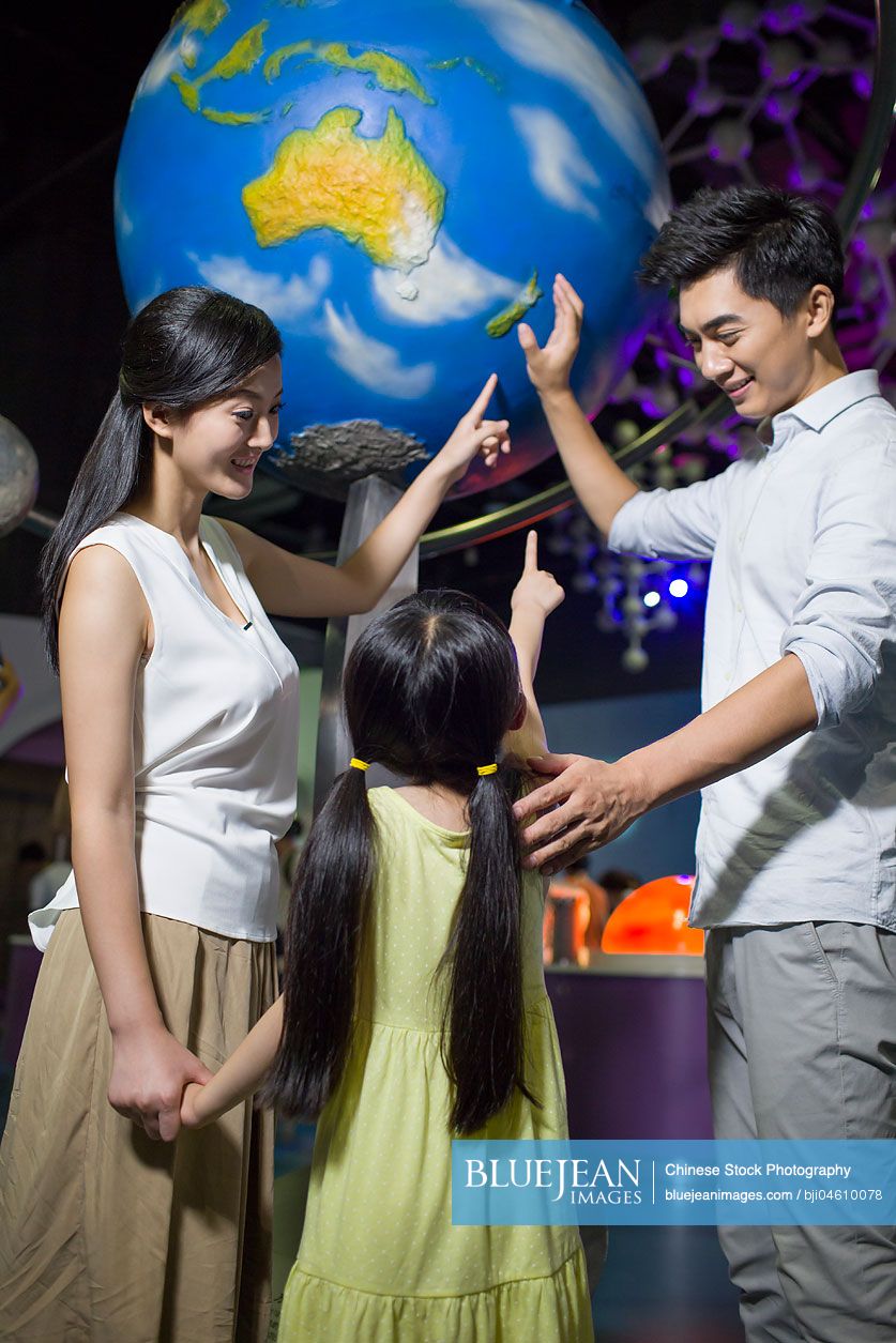 Young Chinese family in science and technology museum