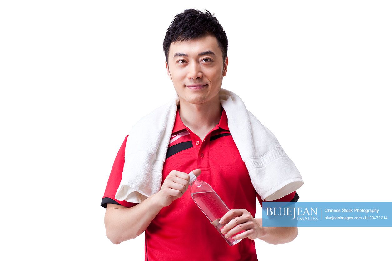 Male Chinese athlete with towel and bottled water