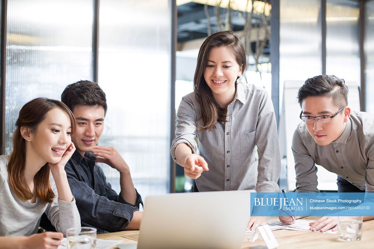 Chinese business people having meeting in board room