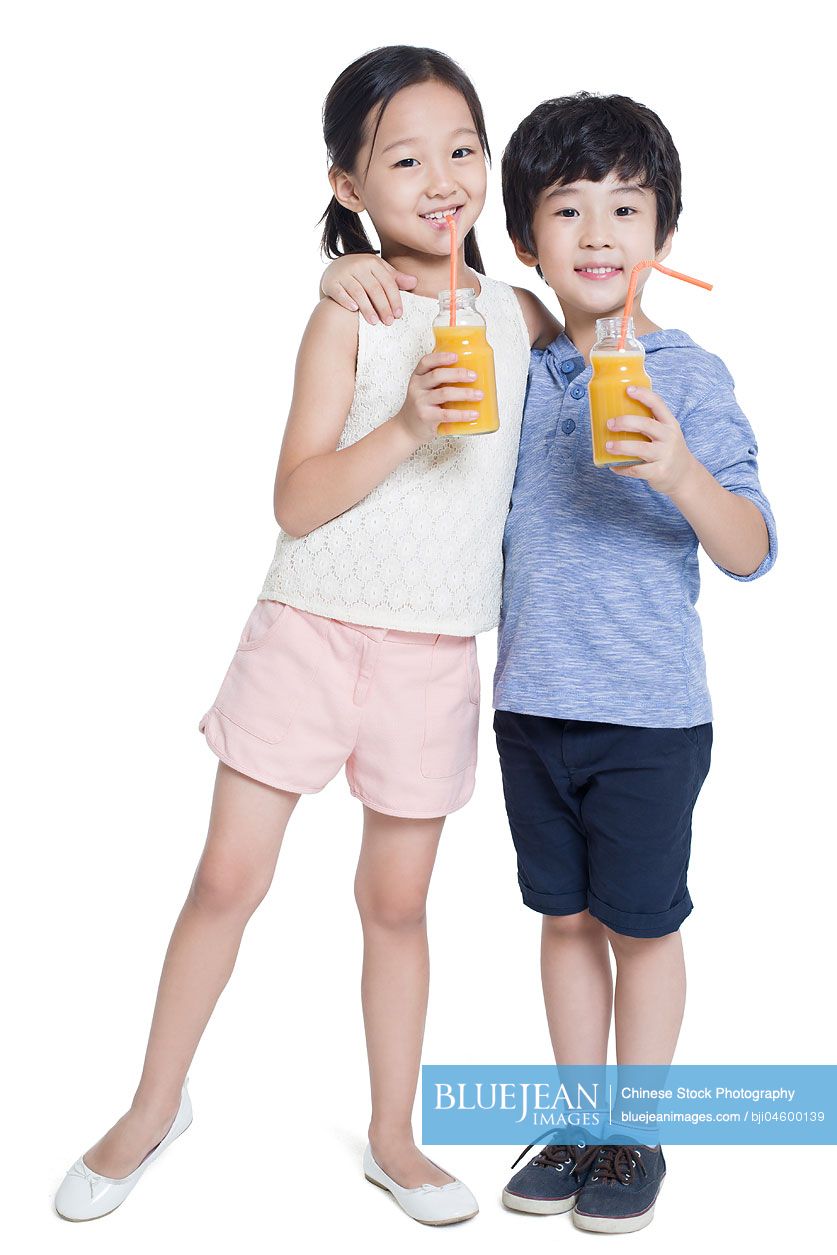 Happy Chinese children drinking juice