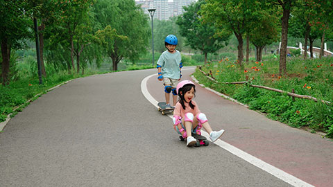 Happy kids skateboarding in the park