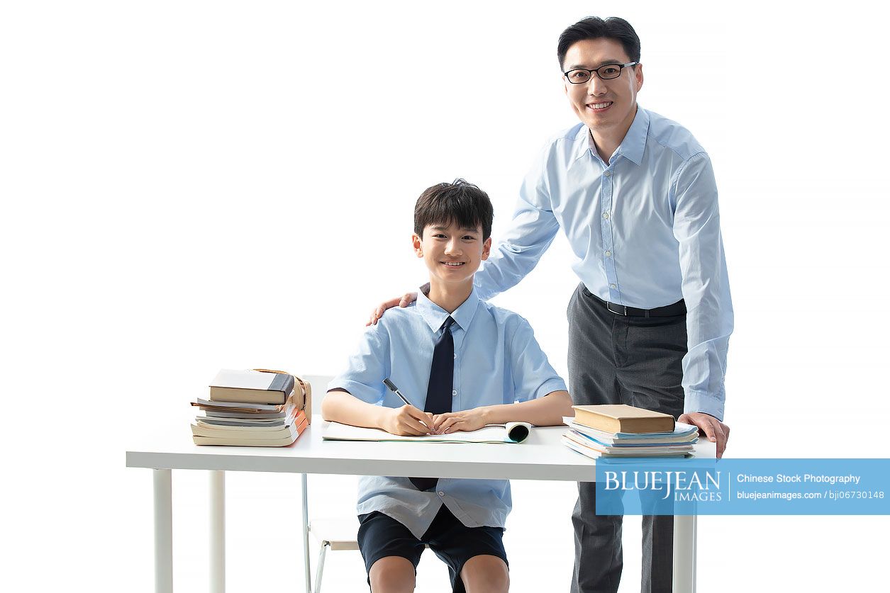 Chinese teacher helping boy with homework