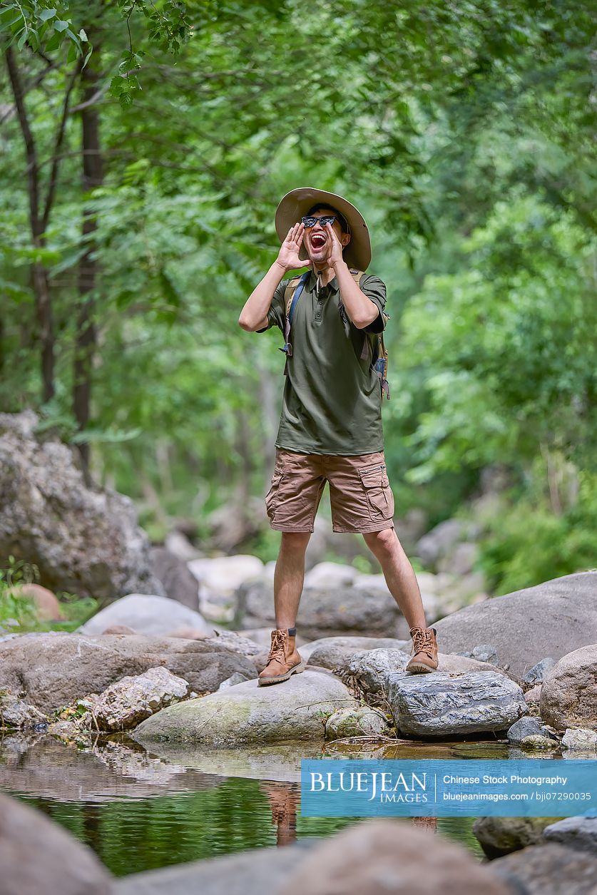 Happy man hiking through the serene beauty of nature