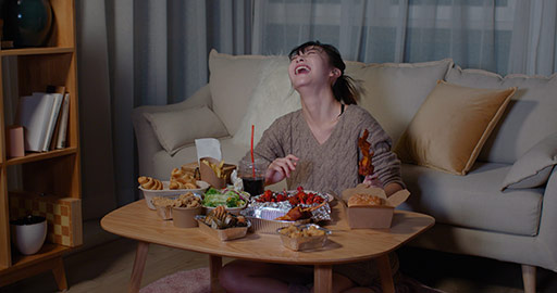 Young Chinese woman eating take-out food at night,4K