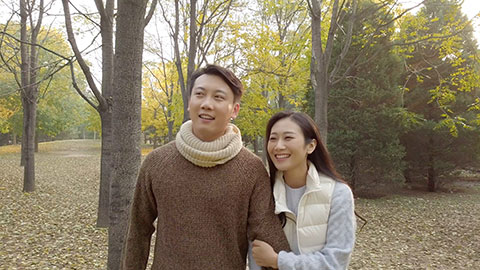 Young Chinese couple dating in autumn woods,4K