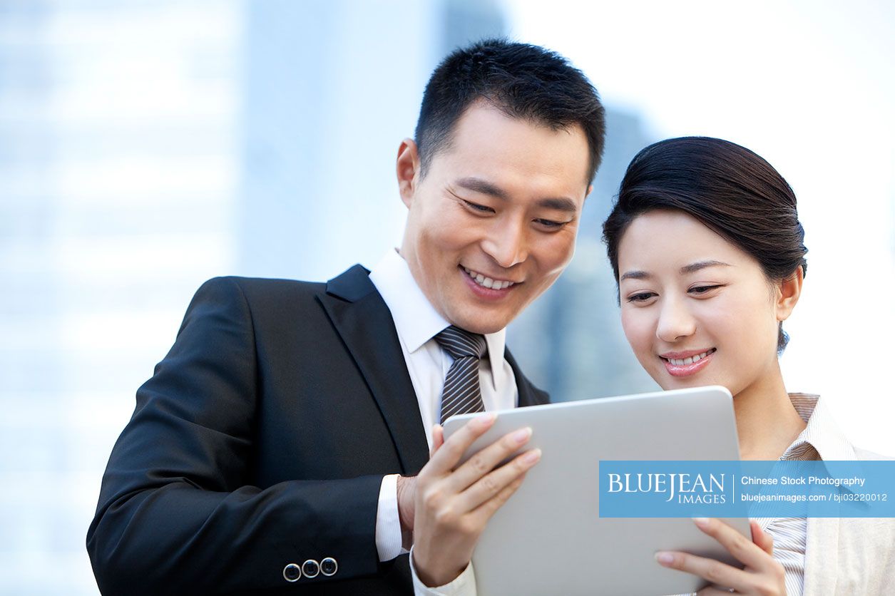 Chinese business colleagues with digital tablet