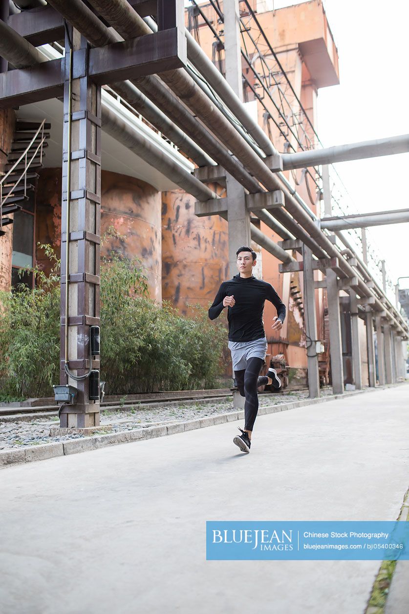 Young Chinese man jogging outdoors
