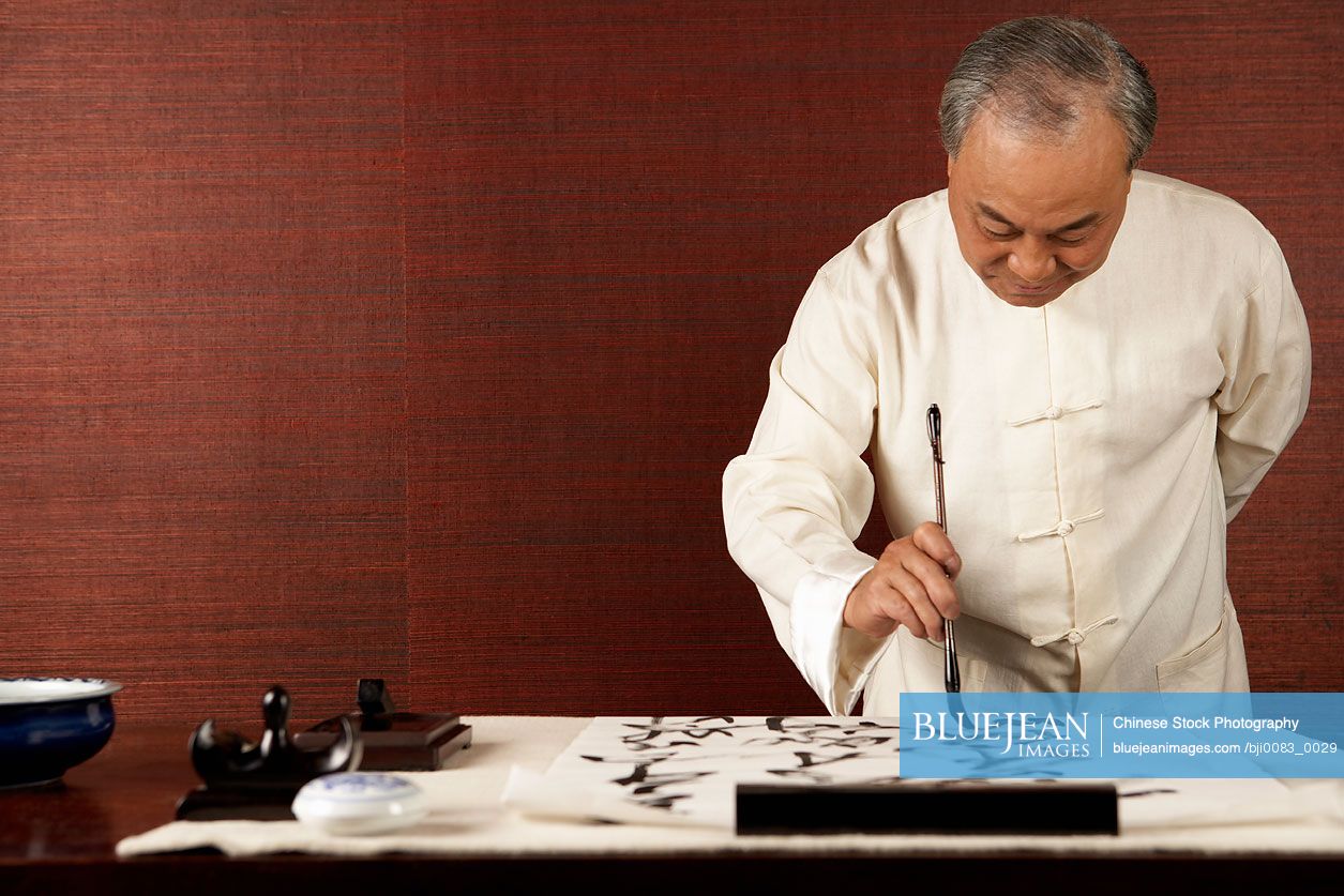 Chinese Elderly Man Practicing Calligraphy