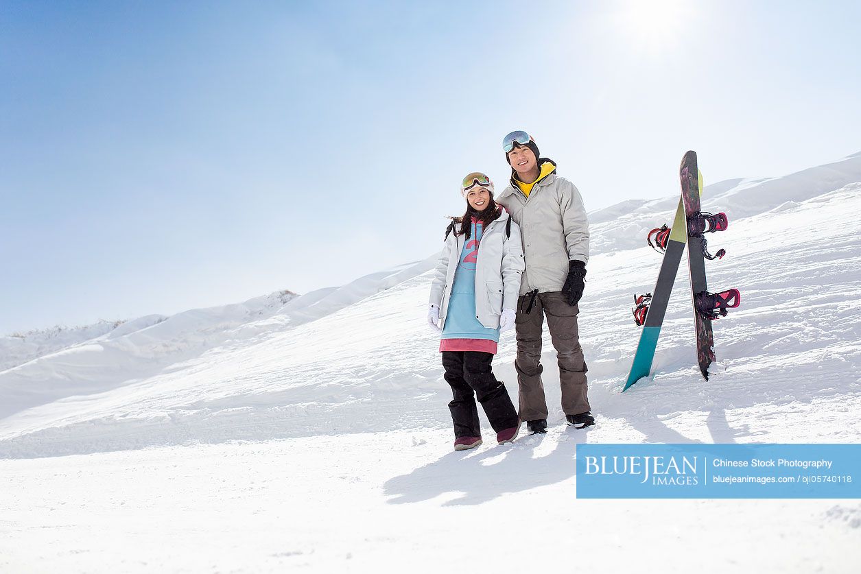 Happy young couple skiing in ski resort