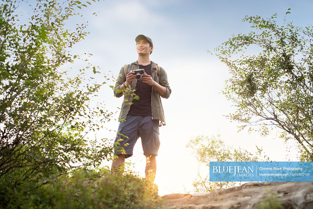 Chinese photographer taking photos outdoors
