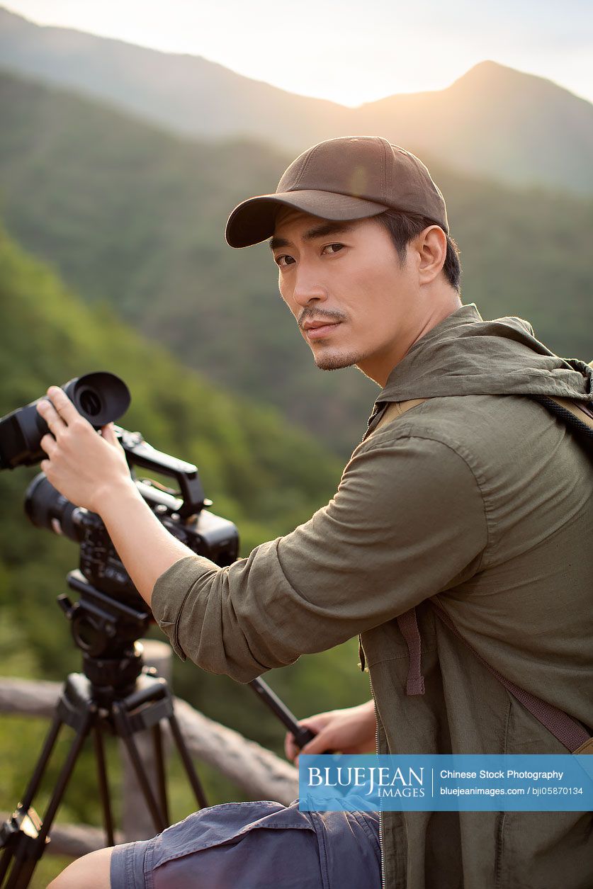 Chinese photographer taking photos outdoors