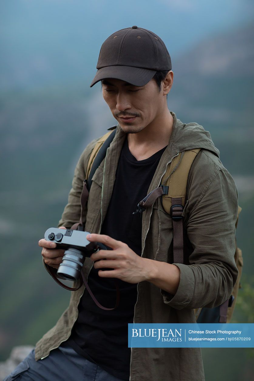 Chinese photographer taking photos outdoors