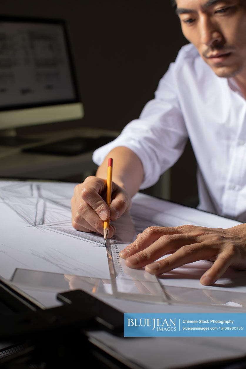 Chinese designer working on construction plan