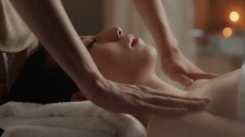 Young Chinese woman receiving facial massage at spa center,4K