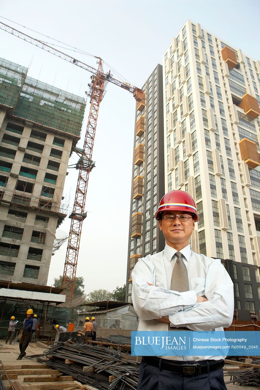 Chinese Construction Contractor Standing On Building Site