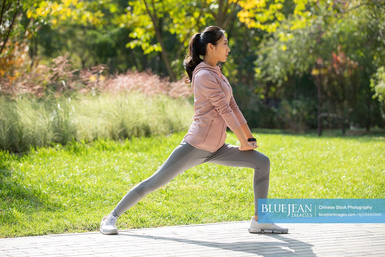 Young Chinese woman exercising in park