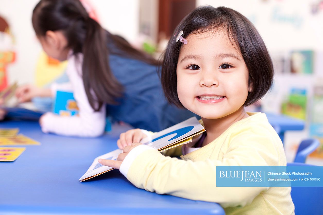 Cute Chinese girl with flash cards